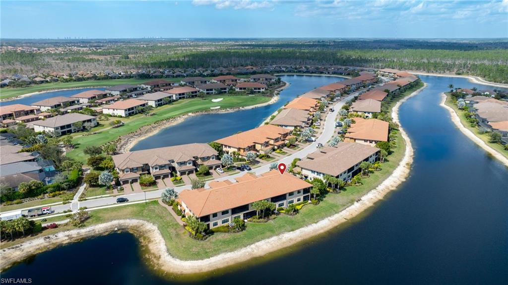 9685 Montelanico Loop, Unit 101 Naples, FL 34119 - Photo 31 of 49 an aerial view of a house with a garden