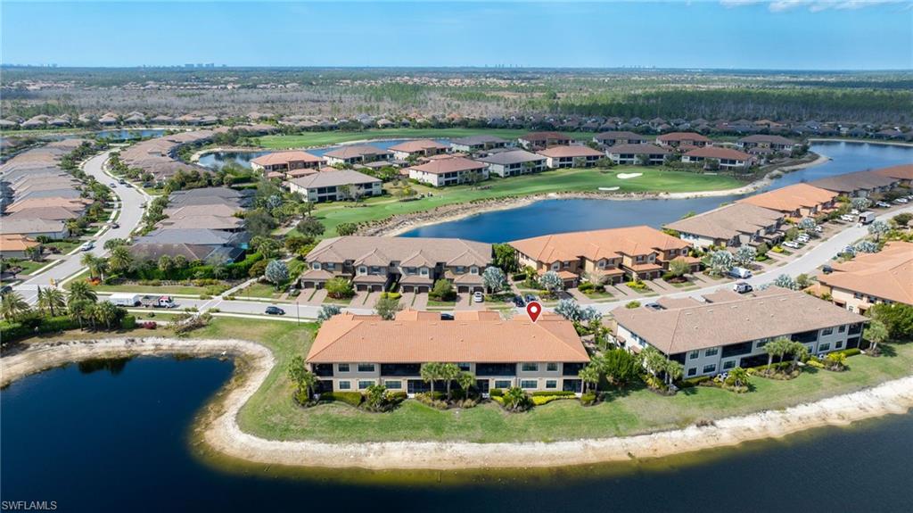 9685 Montelanico Loop, Unit 101 Naples, FL 34119 - Photo 32 of 49 an aerial view of residential houses with outdoor space and swimming pool