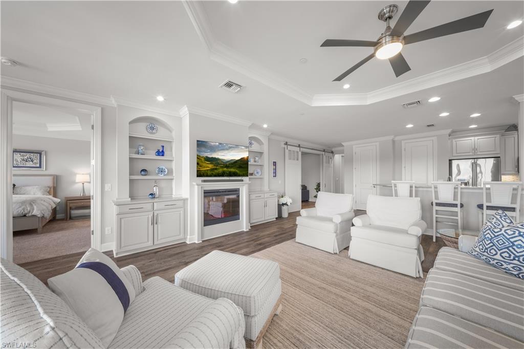 9685 Montelanico Loop, Unit 101 Naples, FL 34119 - Photo 4 of 49 a large bedroom with a bed and furniture