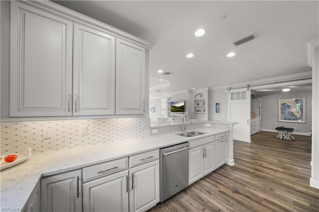 9685 Montelanico Loop, Unit 101 Naples, FL 34119 - Photo 10 of 49 a kitchen with a sink and cabinets