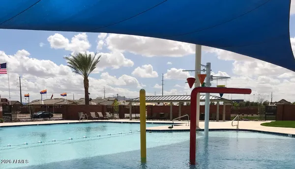 a view of a tall building with a big yard and plants