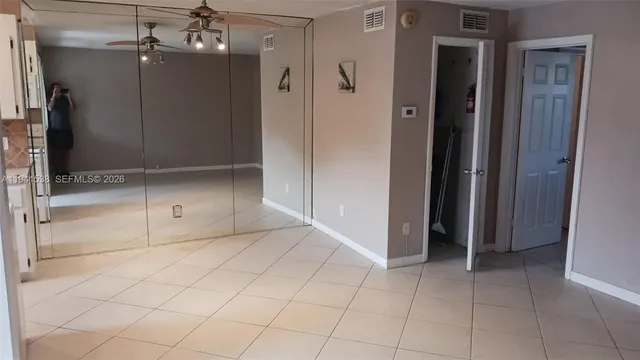 a view of a hallway with wooden shelves