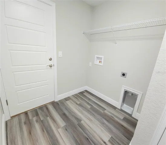 a view of a room with wooden floor
