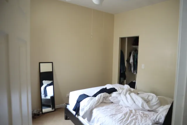 a bedroom with a bed and a mirror