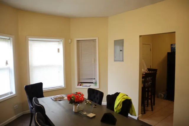 a view of a workspace with furniture and a window