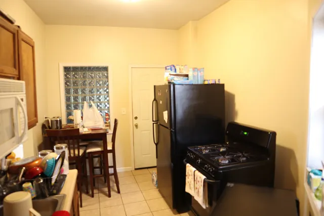a kitchen with a refrigerator and a table