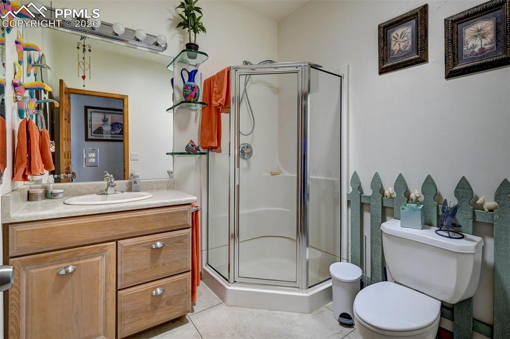 5910 McCart Ranch Circle Elizabeth, CO 80107 - Photo 18 of 50 a bathroom with a granite countertop sink toilet and shower