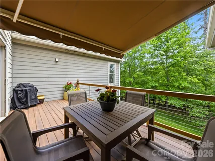 a view of a balcony with two chairs and a table