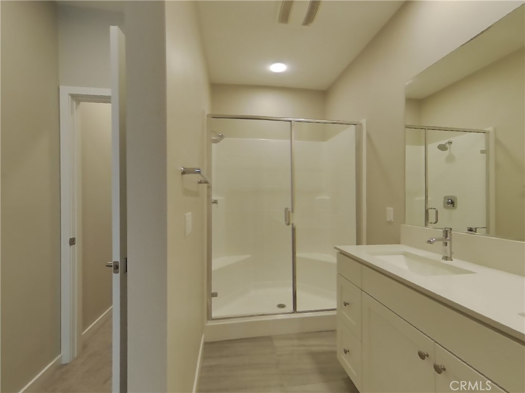 24935 Vermijo Court Wildomar, CA 92595 - Photo 6 of 26 a bathroom with a shower sink and mirror