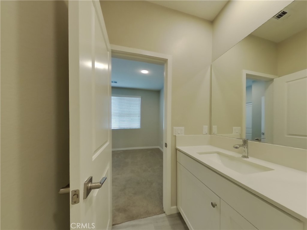 24935 Vermijo Court Wildomar, CA 92595 - Photo 9 of 26 a bathroom with a sink and a mirror