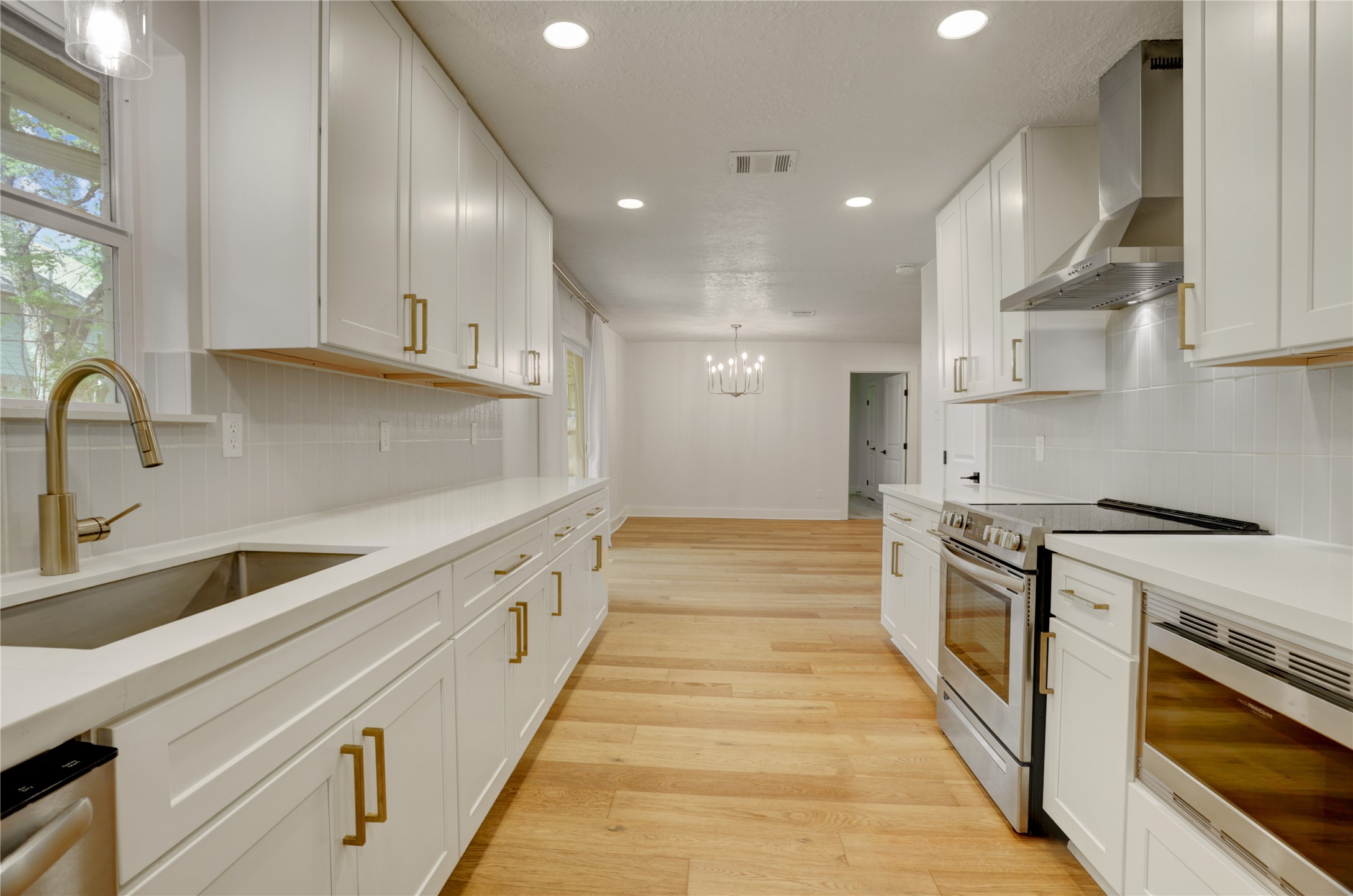 5514 Indigo Street Houston, TX 77096 - Photo 12 of 22 a large kitchen with stainless steel appliances granite countertop a lot of counter space and a sink
