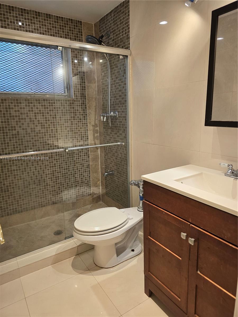 835 Meridian Avenue, Unit 4 Miami Beach, FL 33139 - Photo 9 of 12 a bathroom with a sink toilet and shower