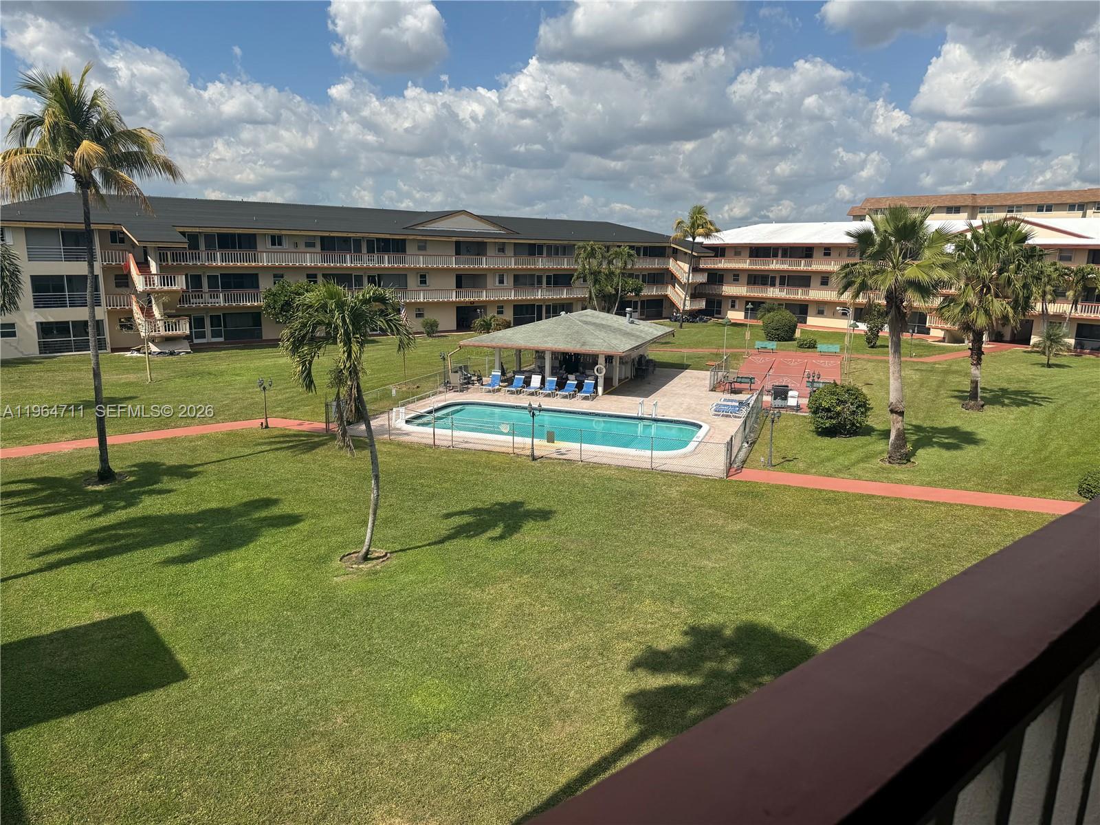 5300 Washington Street, Unit B329 Hollywood, FL 33021 - Photo 11 of 20 a view of a swimming pool with a yard