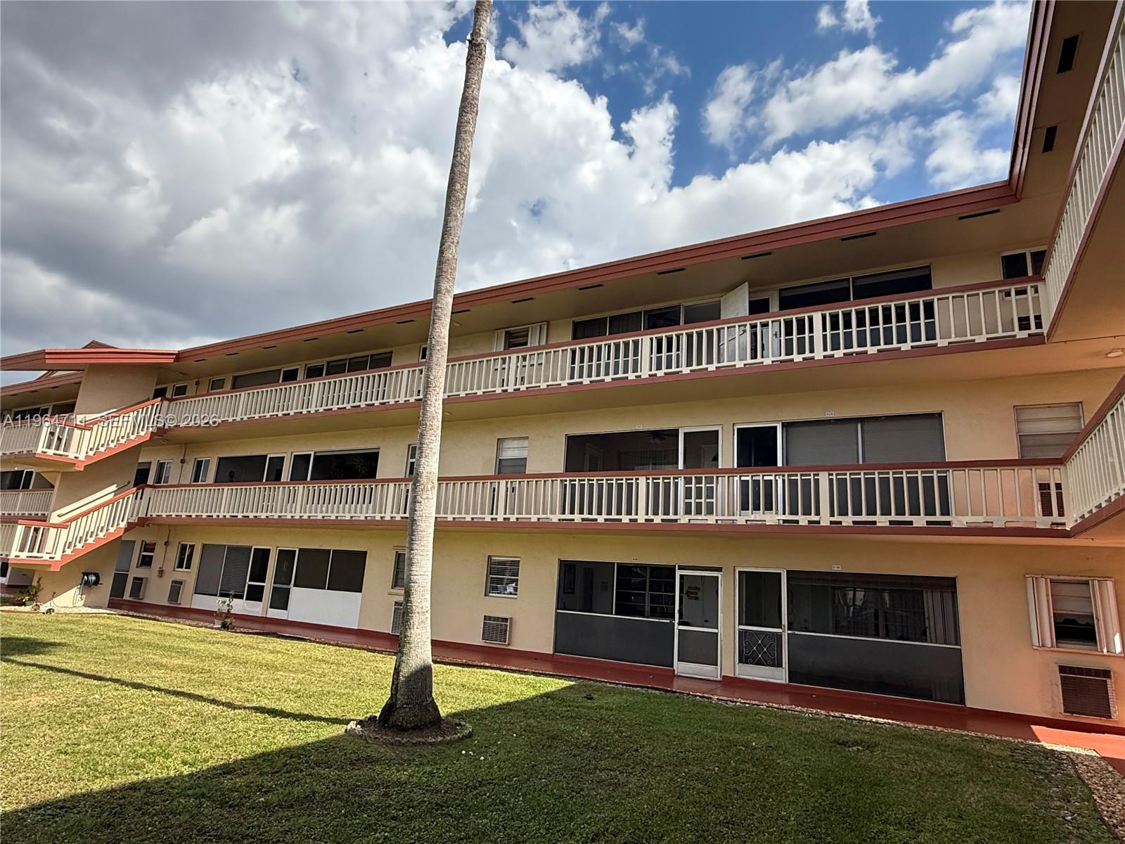 5300 Washington Street, Unit B329 Hollywood, FL 33021 - Photo 13 of 20 a front view of a building with a garden