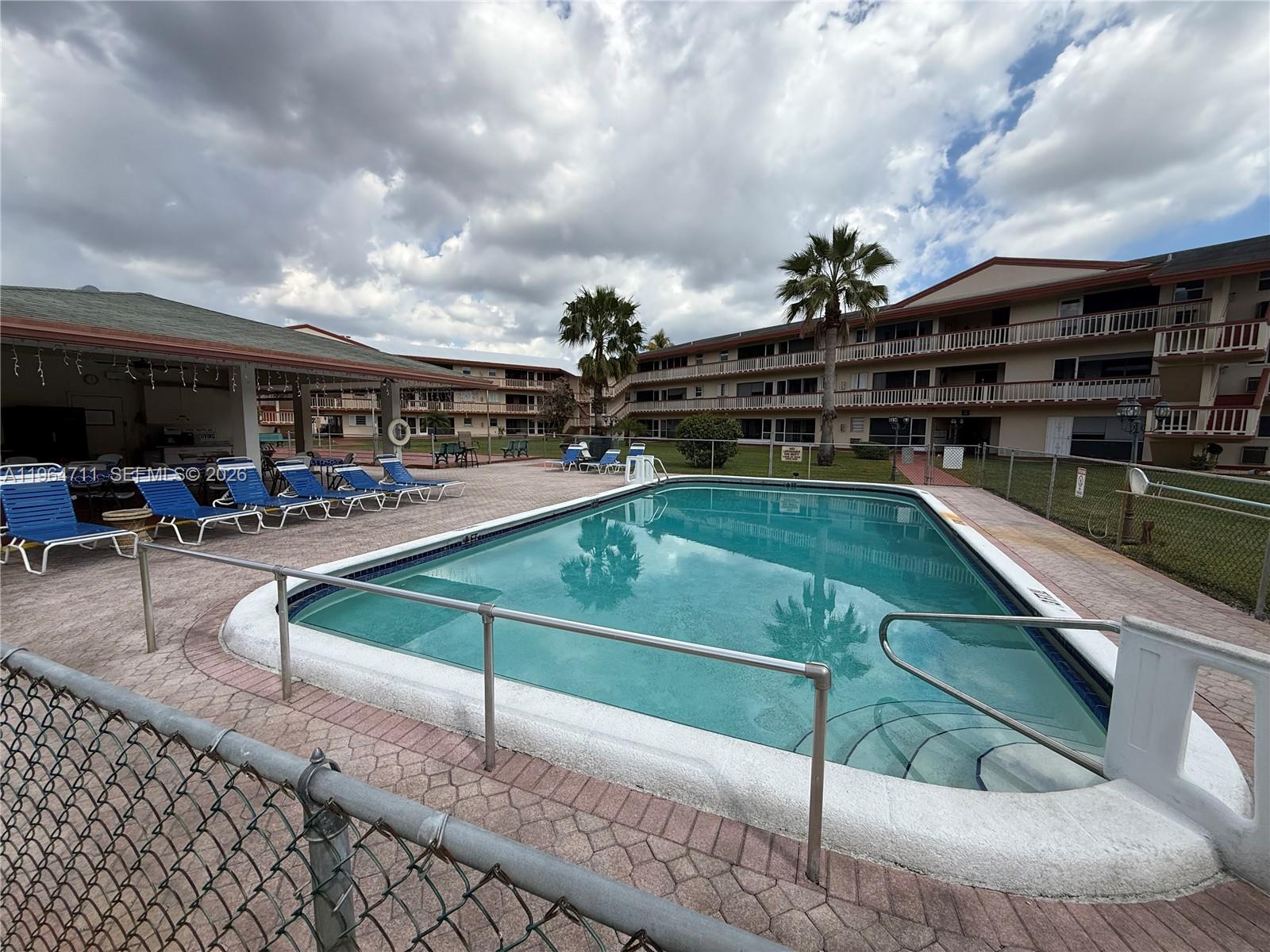 5300 Washington Street, Unit B329 Hollywood, FL 33021 - Photo 14 of 20 a view of a backyard with a patio and couches chairs