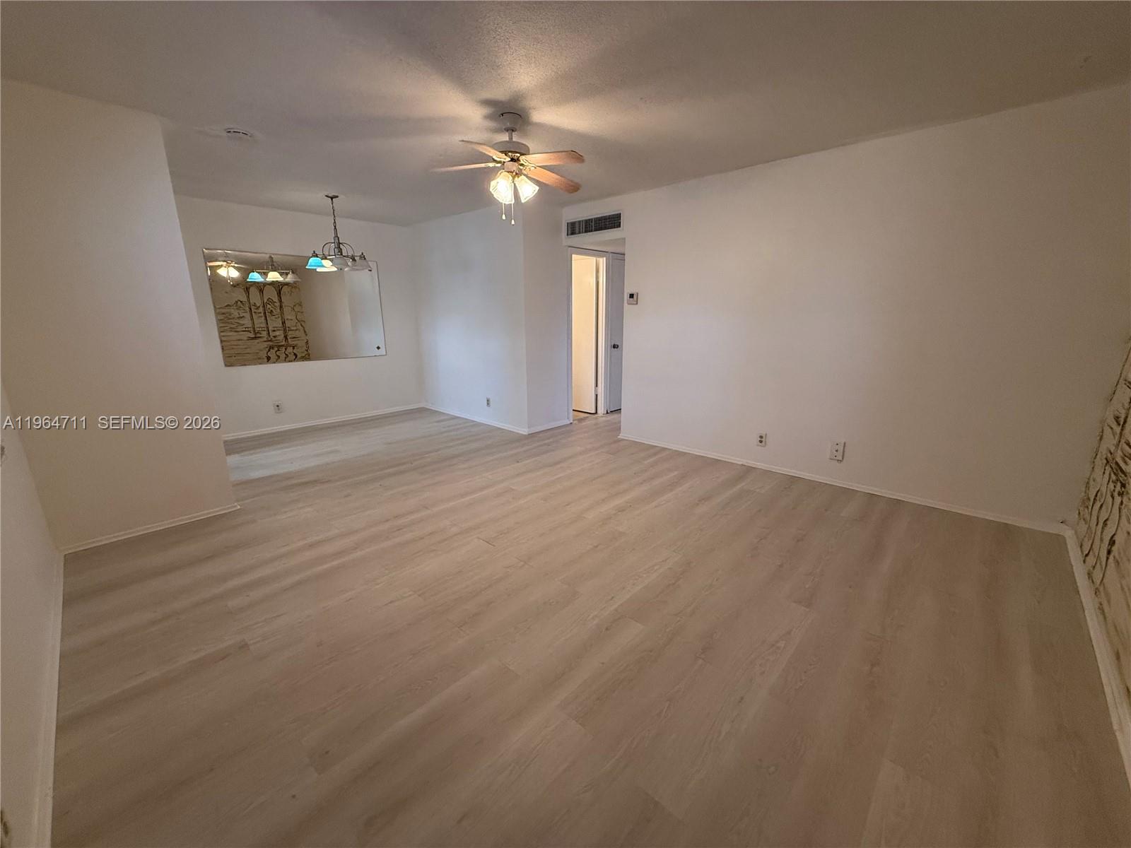 5300 Washington Street, Unit B329 Hollywood, FL 33021 - Photo 2 of 20 wooden floor in an empty room with a window