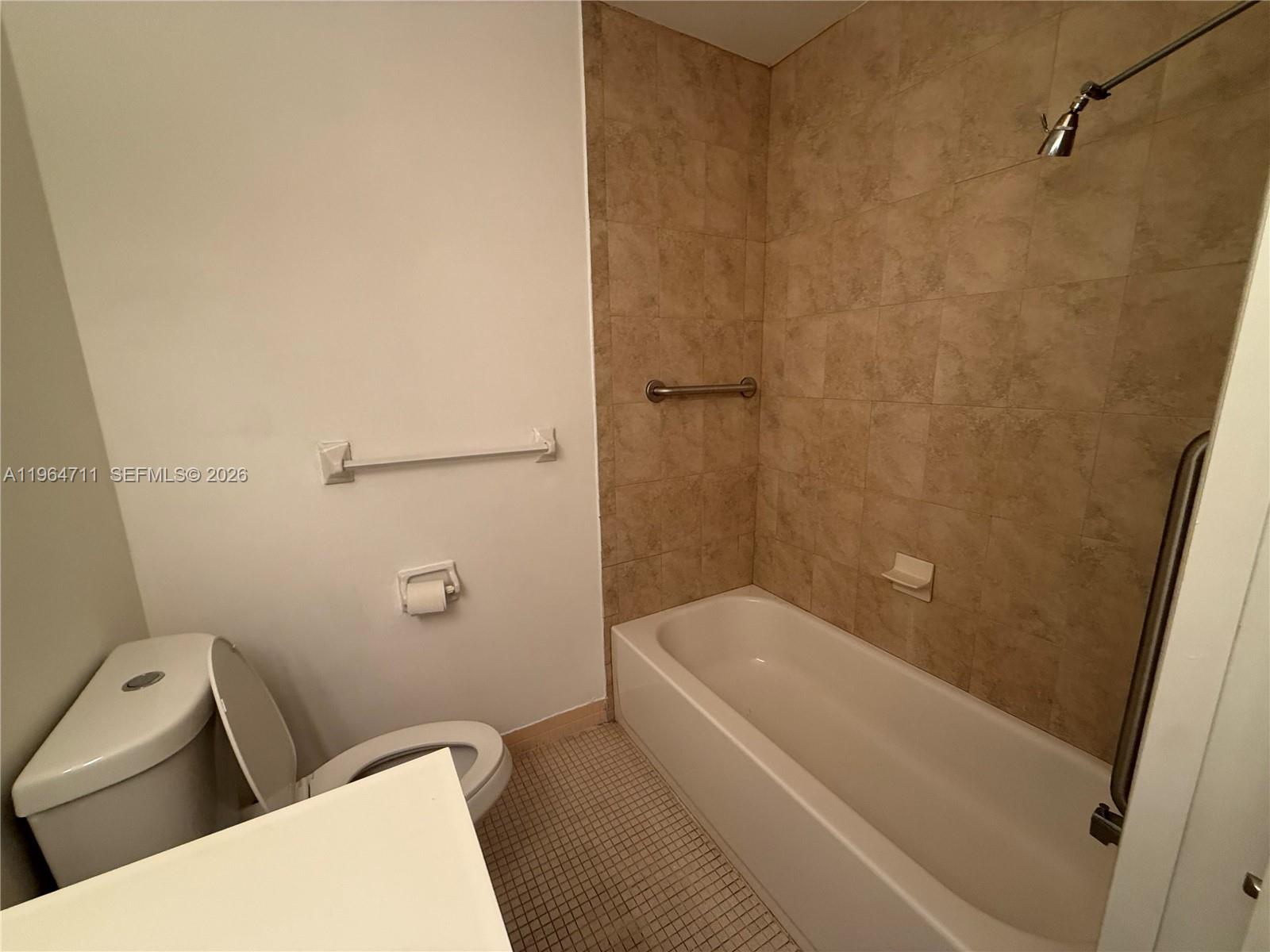 5300 Washington Street, Unit B329 Hollywood, FL 33021 - Photo 6 of 20 a bathroom with a toilet and shower