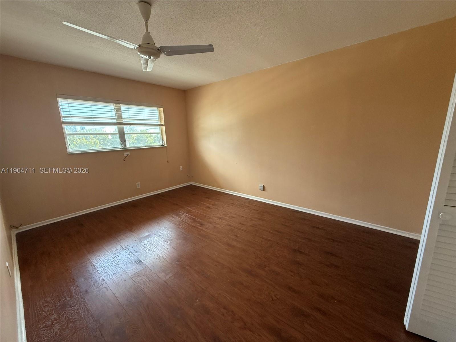 5300 Washington Street, Unit B329 Hollywood, FL 33021 - Photo 7 of 20 an empty room with wooden floor fan and windows