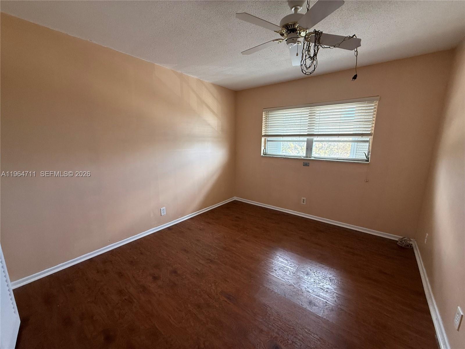 5300 Washington Street, Unit B329 Hollywood, FL 33021 - Photo 8 of 20 an empty room with wooden floor chandelier and windows