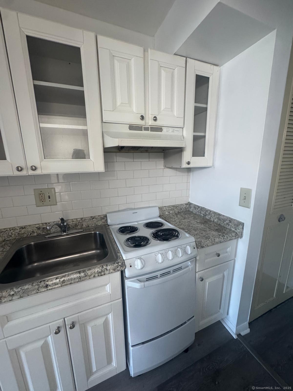 169 Birdseye Street, Unit C2 Bridgeport, CT 06604 - Photo 3 of 10 a white stove top oven sitting inside of a kitchen