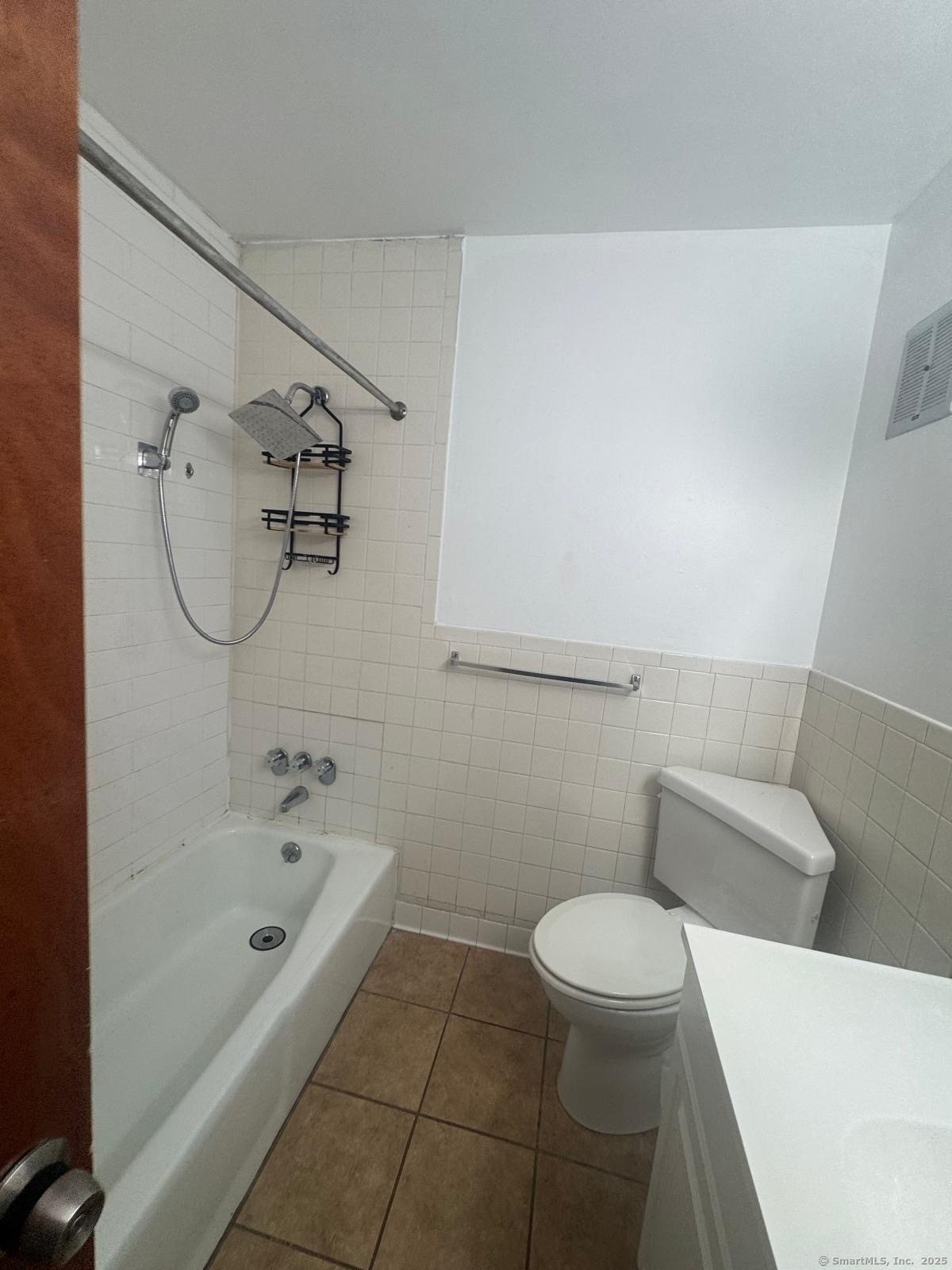 169 Birdseye Street, Unit C2 Bridgeport, CT 06604 - Photo 9 of 10 a bathroom with a bathtub and toilet