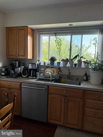 a kitchen with sink cabinets and wooden floor