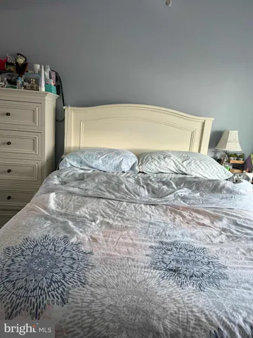 a bedroom with a bed and cabinets