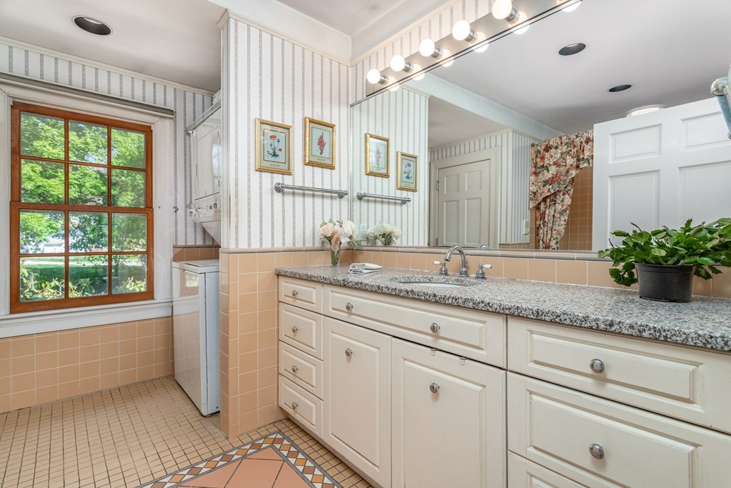 5 Lancaster Road Shirley, MA 01464 - Photo 12 of 42 a bathroom with a granite countertop sink a large mirror and a window