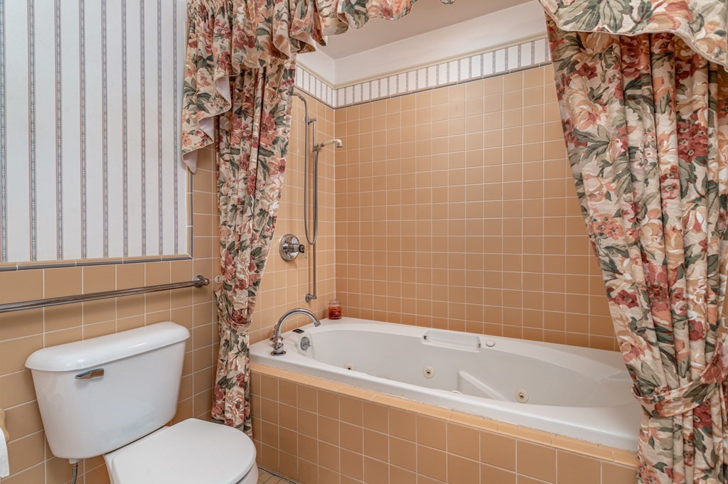 5 Lancaster Road Shirley, MA 01464 - Photo 13 of 42 a white bath tub sitting next to a white toilet and sink