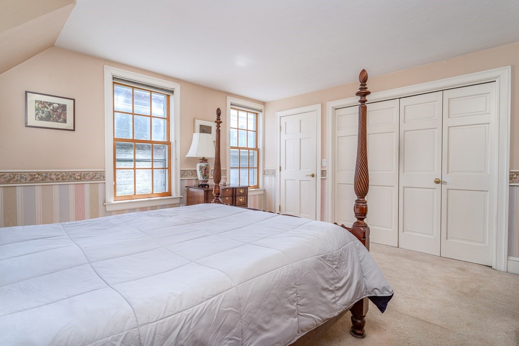5 Lancaster Road Shirley, MA 01464 - Photo 17 of 42 a spacious bedroom with a large bed and a window