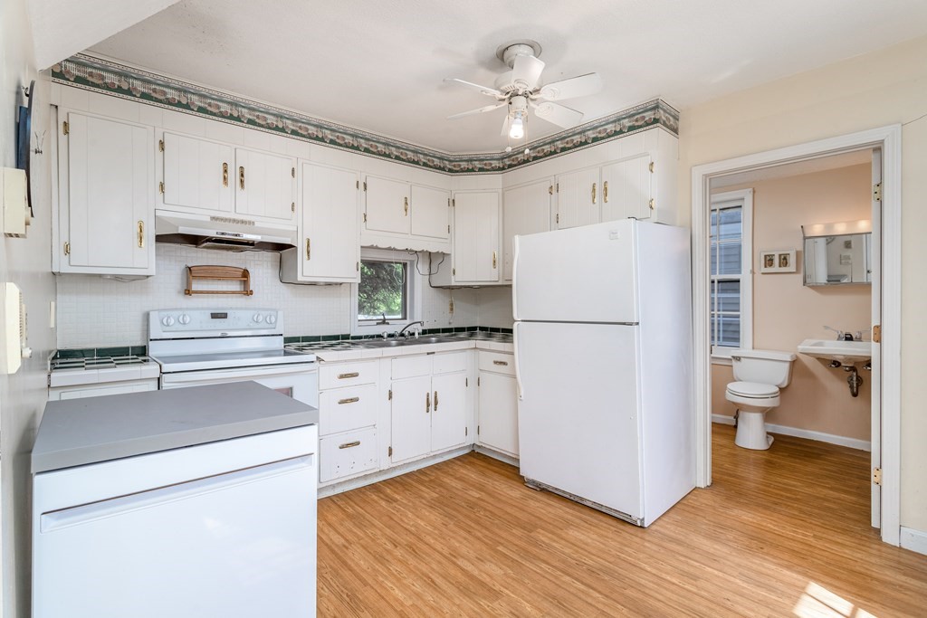 5 Lancaster Road Shirley, MA 01464 - Photo 25 of 42 a kitchen with stainless steel appliances a refrigerator a stove a sink and white cabinets