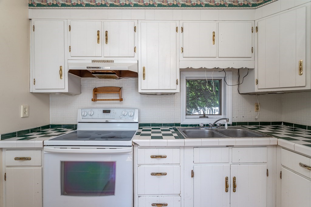 5 Lancaster Road Shirley, MA 01464 - Photo 26 of 42 a kitchen with granite countertop white cabinets and white appliances