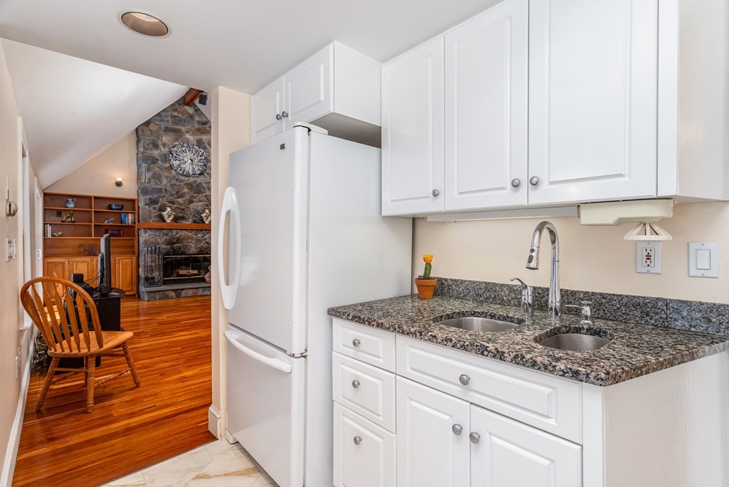 5 Lancaster Road Shirley, MA 01464 - Photo 6 of 42 a kitchen with granite countertop a sink and cabinets