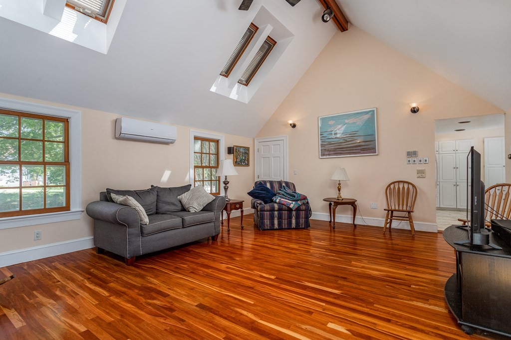 5 Lancaster Road Shirley, MA 01464 - Photo 8 of 42 a living room with furniture and a wooden floor