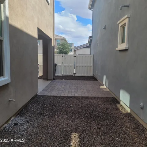 a view of a yard with wooden fence