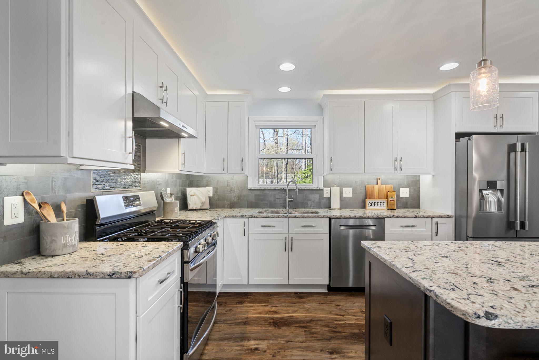 18607 Cabin Road Triangle, VA 22172 - Photo 12 of 64 a kitchen with stainless steel appliances granite countertop a sink stove and refrigerator