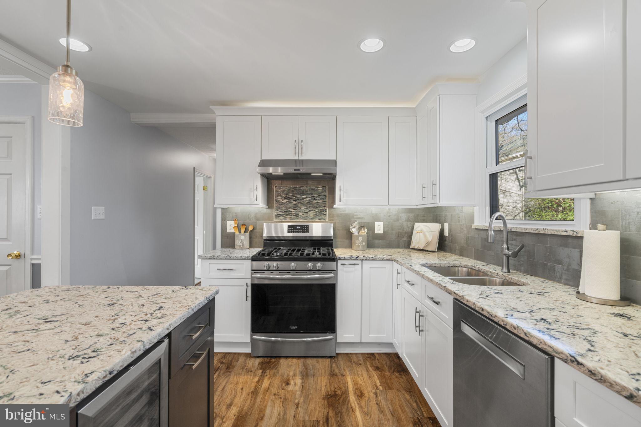 18607 Cabin Road Triangle, VA 22172 - Photo 13 of 64 a kitchen with a sink stove and cabinets