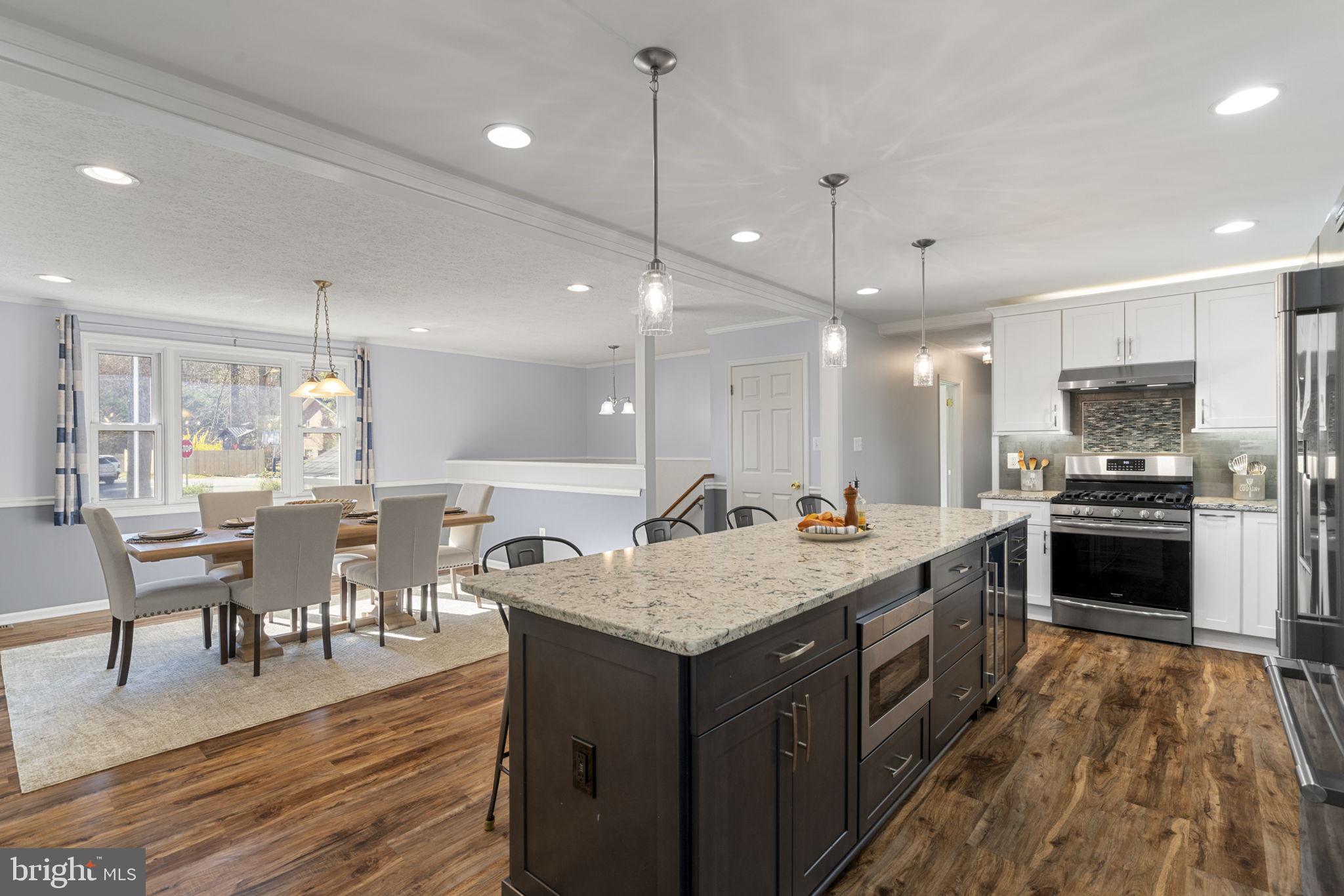 18607 Cabin Road Triangle, VA 22172 - Photo 14 of 64 a kitchen with a sink stove and wooden floor