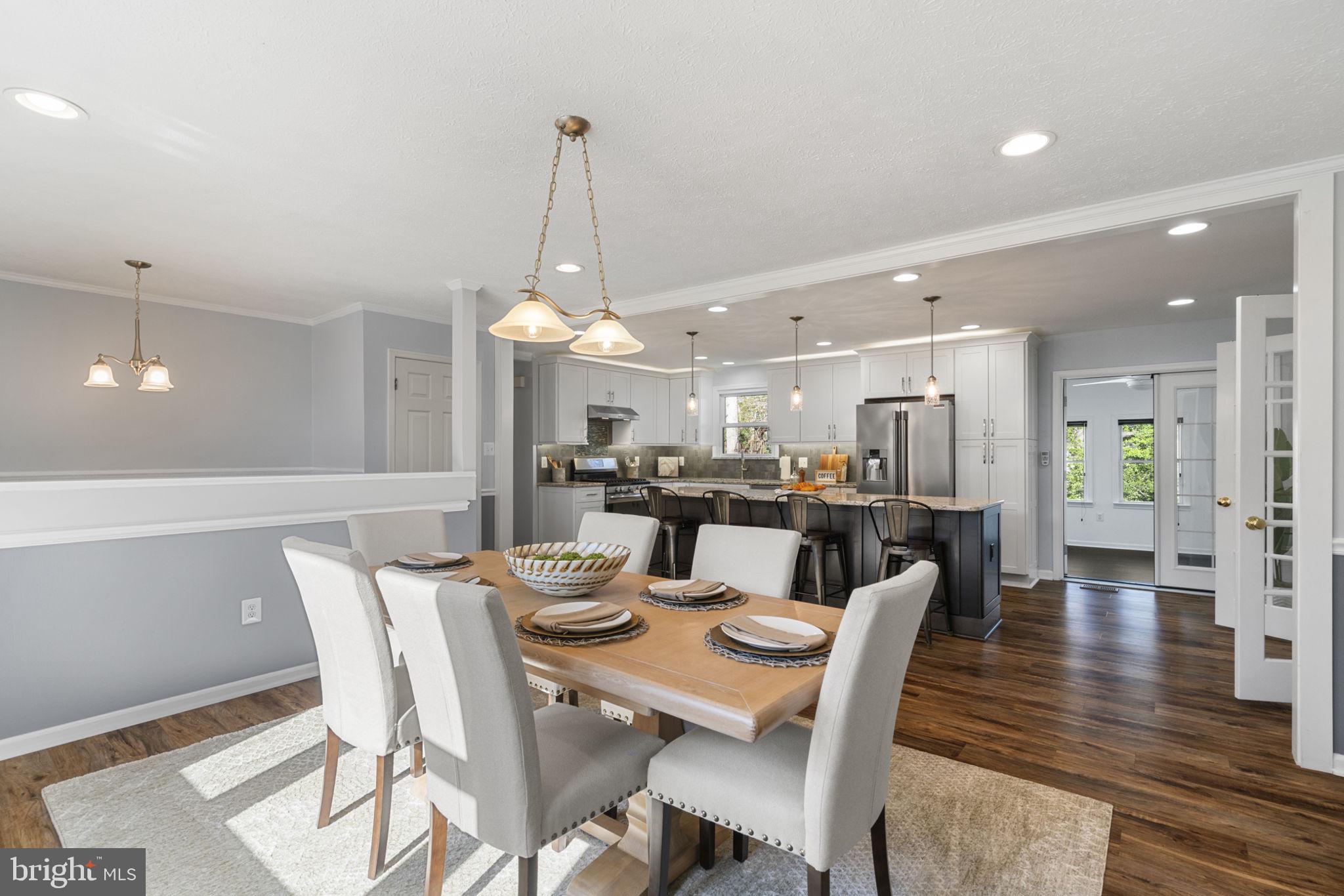 18607 Cabin Road Triangle, VA 22172 - Photo 16 of 64 a dining room with furniture a chandelier and wooden floor