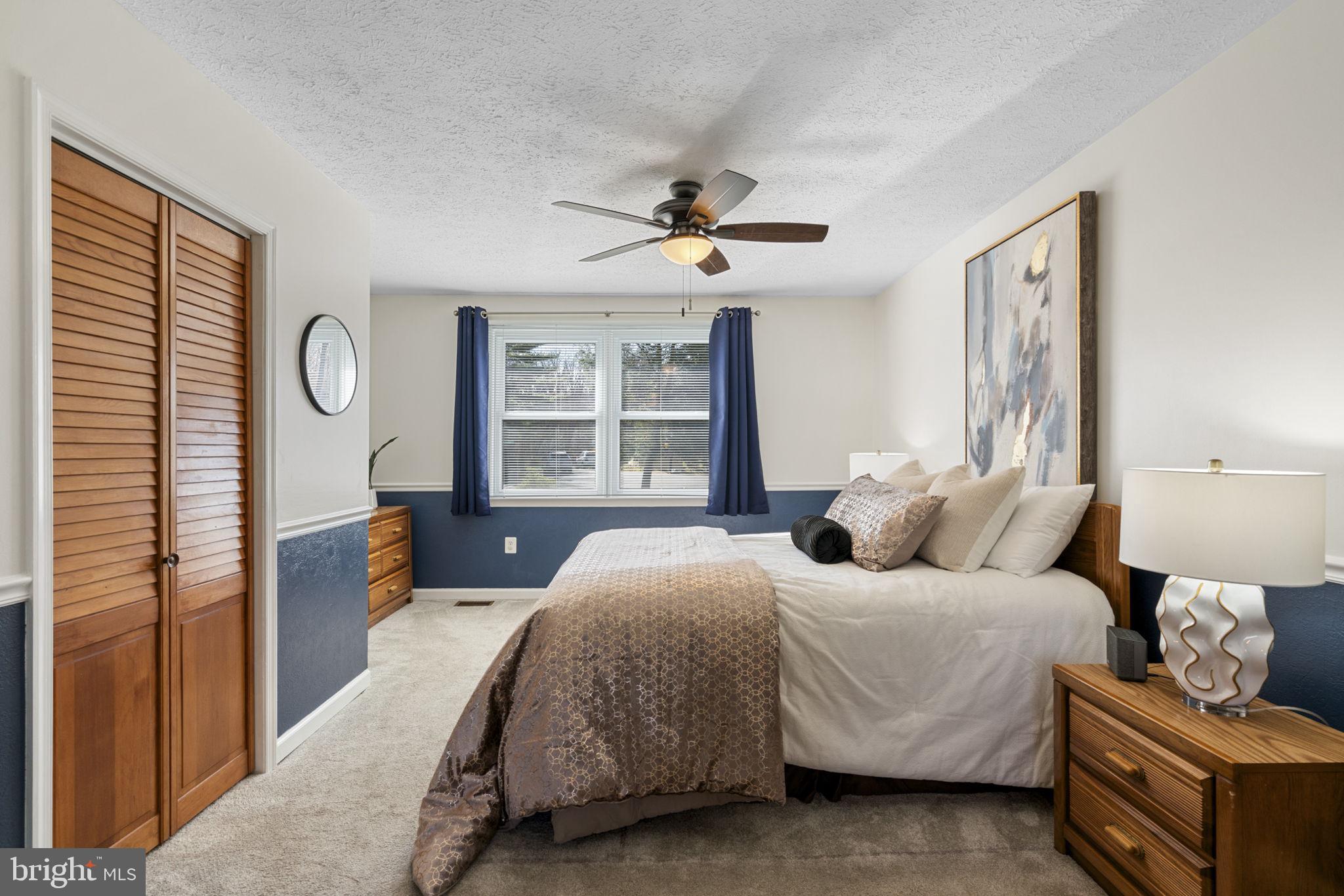 18607 Cabin Road Triangle, VA 22172 - Photo 23 of 64 a bedroom with a bed couches and window with outer view