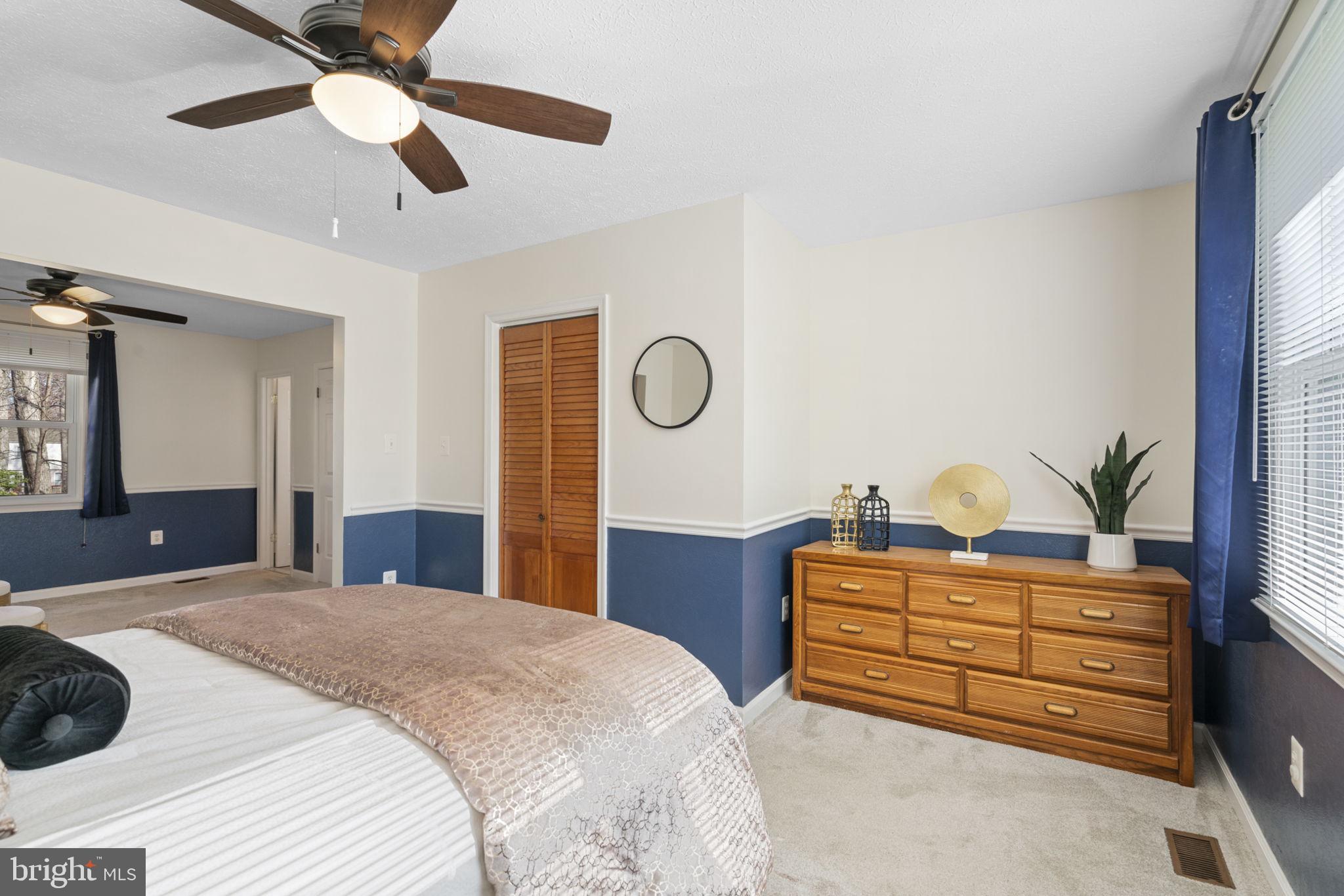 18607 Cabin Road Triangle, VA 22172 - Photo 24 of 64 a bedroom with a bed and a chandelier