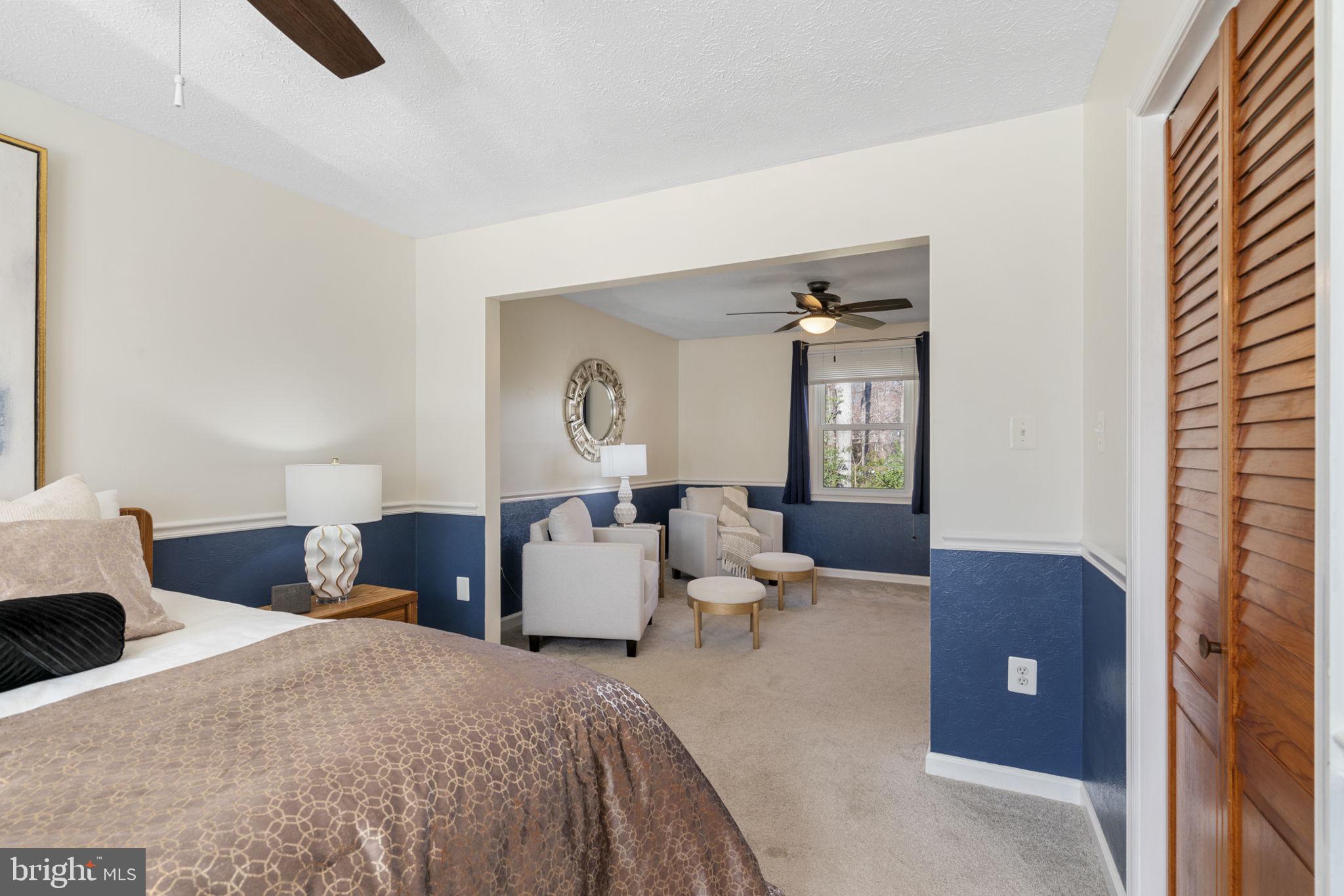 18607 Cabin Road Triangle, VA 22172 - Photo 26 of 64 a bedroom with a large bed and chandelier