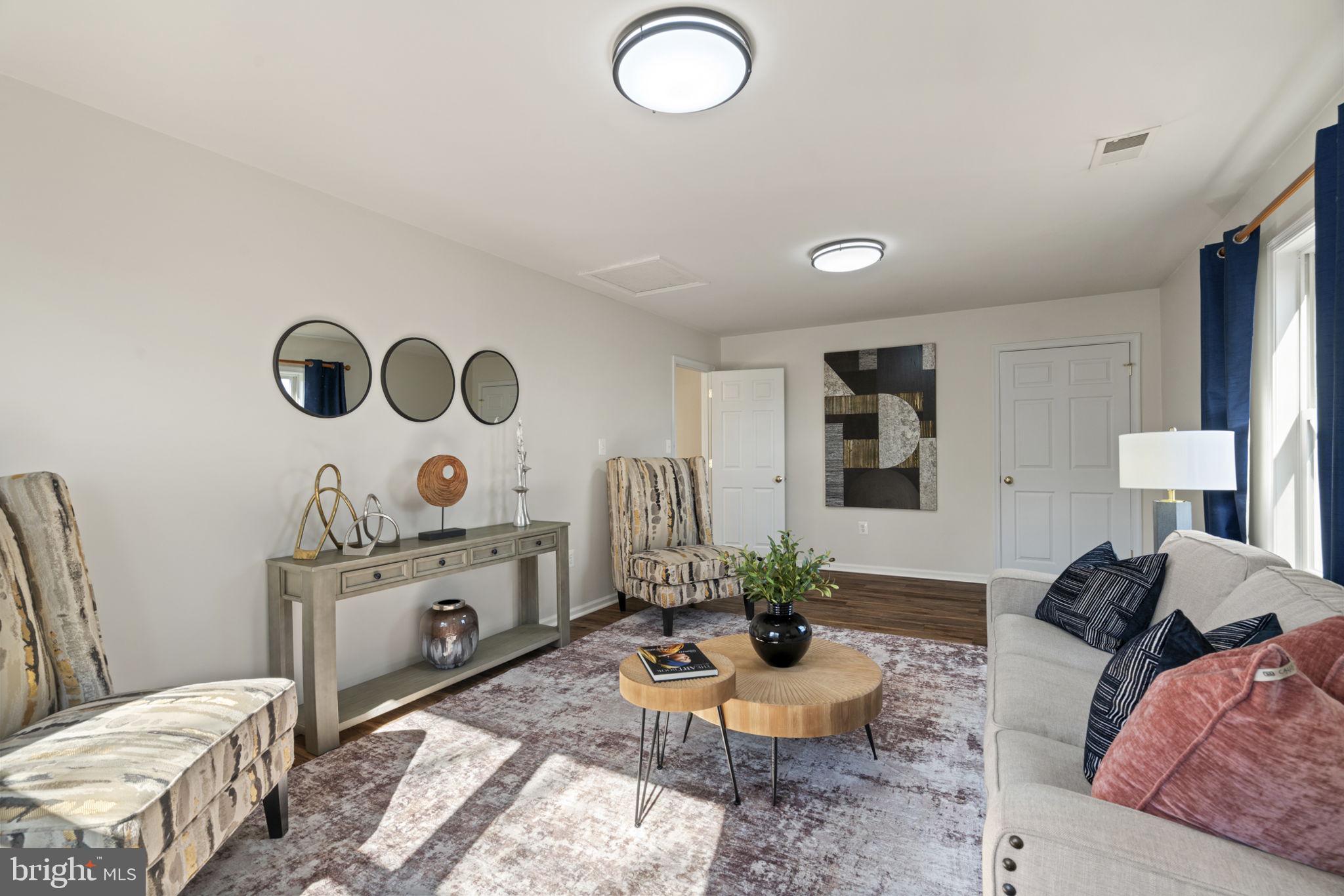 18607 Cabin Road Triangle, VA 22172 - Photo 34 of 64 a living room with furniture and painting on the wall