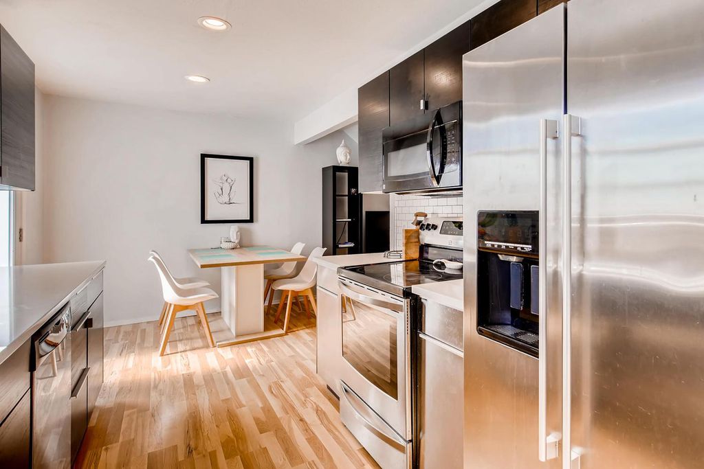 1312 Cometa Street, Unit A Austin, TX 78721 - Photo 2 of 18 Kitchen with stainless steel appliances, light wood-type flooring, backsplash, and recessed lighting
