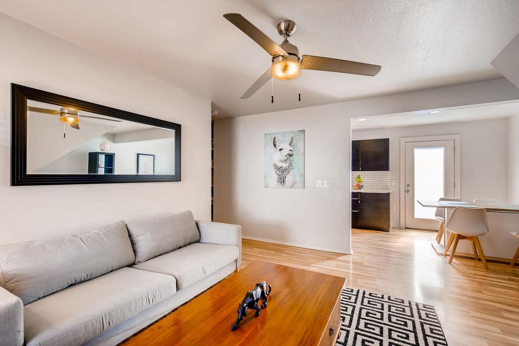 1312 Cometa Street, Unit A Austin, TX 78721 - Photo 5 of 18 Living area with light wood-style flooring, ceiling fan, and a textured ceiling