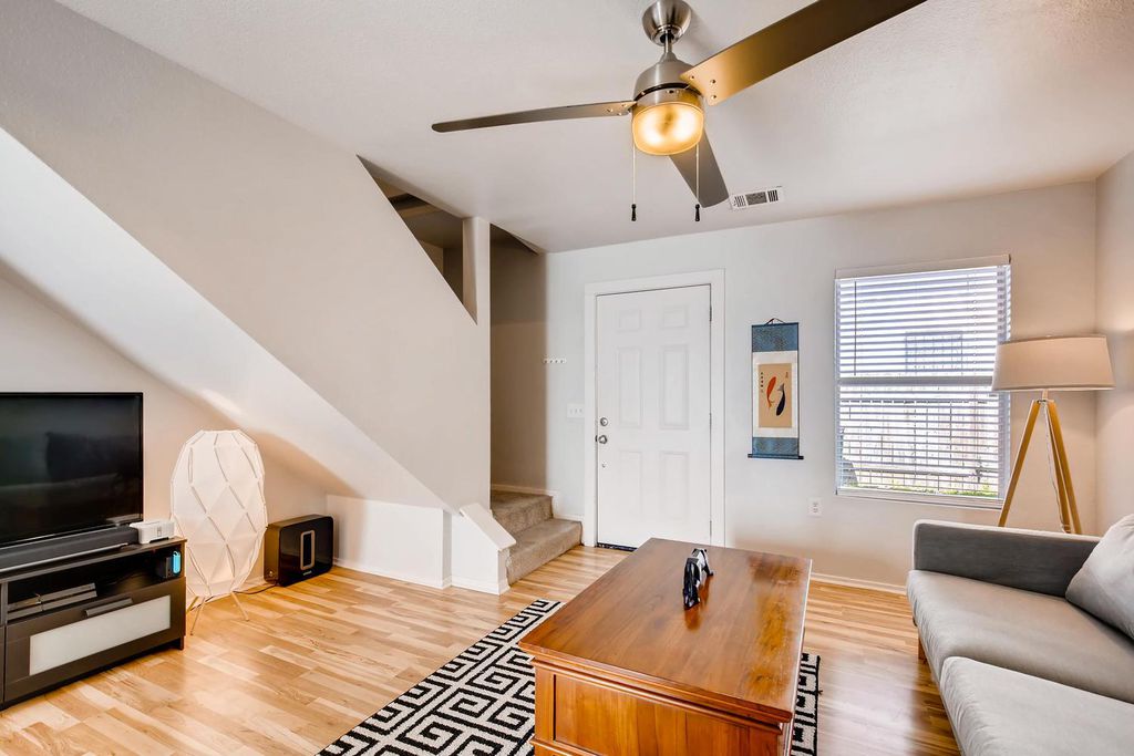 1312 Cometa Street, Unit A Austin, TX 78721 - Photo 6 of 18 Living room featuring stairway, light wood-type flooring, and ceiling fan