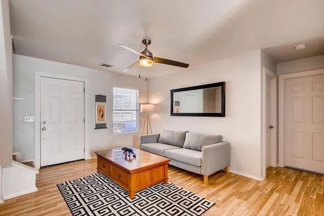 a living room with furniture and a rug