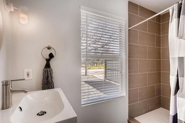 a bathroom with a sink and a window