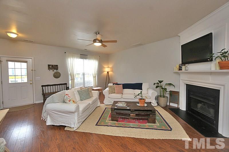 5121 Echo Ridge Road Raleigh, NC 27612 - Photo 2 of 16 a living room with furniture fireplace and flat screen tv