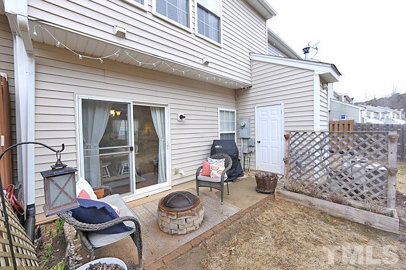 5121 Echo Ridge Road Raleigh, NC 27612 - Photo 13 of 16 a patio with table and chairs and potted plants